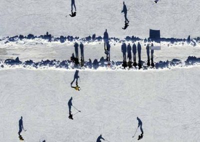 shadows from hockey skaters are reflected on the frozen water of Plaster Rock in New Brunswick in an overhead picture from a helicopter.