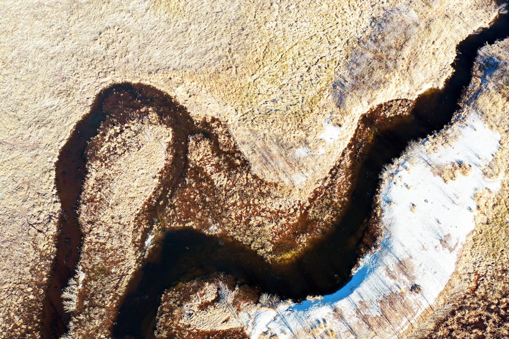 An overhead view of a streambed in winter