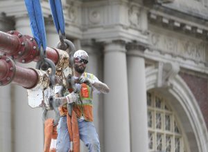 a construction worker attaches rigging in New york City, during progress photography photo shoot.