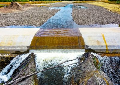 A dam with water from a riverbed, taken during progress photography stage