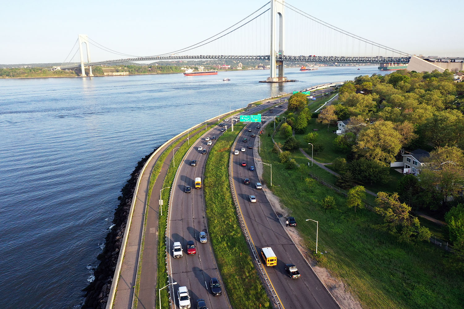 An aerial view of the Belt Parkway and distant Verrazzano Bridge at sunrise
